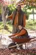 Photo: Senior man and grandson (7-9) collecting autumn leaves in garden, boy sitting in wheelbarrow, smiling, portrait Senior man and grandson (7-9) collecting autumn leaves in garden, boy sitting in wheelbarrow, smiling, portrait