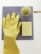 High angle view of a washing up glove with a brush and sponge