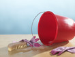 Close-up of a pair of washing up gloves and a washing brush with a red bucket