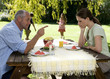 A couple arguing whilst in the garden with their children