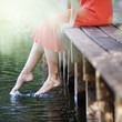 Young woman sitting by a river