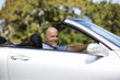 A senior man driving a car
