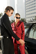 A wealthy couple unlocking their car