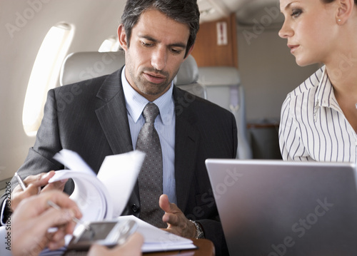 Photo: Three business colleagues working on a flight Three business colleagues working on a flight