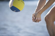 A woman playing beach volleyball
