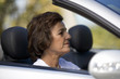 A senior woman driving a car