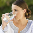 A young woman drinking a glass of water