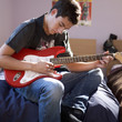 A teenage boy with a guitar