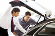 A young man admiring a new car