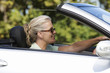 A senior woman driving a car