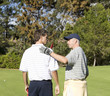Two men playing golf