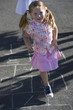Young girls playing hopscotch