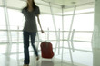 A woman walking through an airport