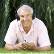 A senior man listening to music