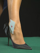 Detail of woman's foot with playing card