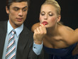 Woman kissing dice for man