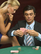 Woman looking at man playing poker