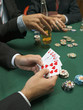 Detail of man holding playing cards at poker game