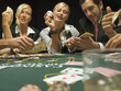 Woman holding dealer button at poker game