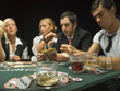 Detail of drinks and poker chips with people in background