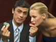 Woman kissing dice for man