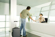 A receptionist greeting a visitor