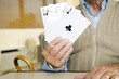 An elderly man playing cards