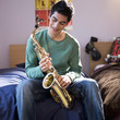 A teenage boy with a saxophone