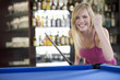 A teenage girl playing pool