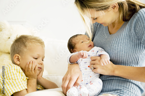 Photo: A mother and her son with a new baby A mother and her son with a new baby