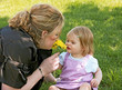 Mom and Daughter Smelling a Flower