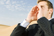 A man in a suit shouting for attention
