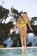 A teenage girl having fun by a swimming pool