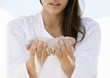 A woman with sand running through her hands