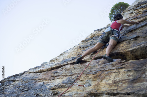 Photo: A climber climbing a rock face A climber climbing a rock face
