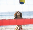 A woman playing beach volleyball