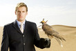 A man in a suit with a hawk