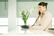 A receptionist talking on the telephone