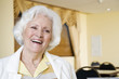 An elderly woman laughing