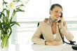 A receptionist talking on the telephone