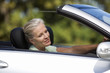 A senior woman driving a car