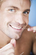 A young man flossing his teeth