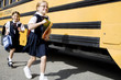 Two schoolgirls running for the school bus