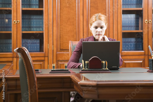 Photo: Business woman in classic wood working place Business woman in classic wood working place