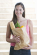 A young girl with a bag of shopping