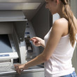 A young woman using a cash machine