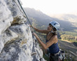 A climber climbing a rock face