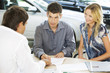 A young couple buying a new car