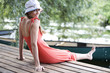 Young woman sitting by a river