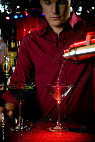 Photo: A barman mixing cocktails A barman mixing cocktails